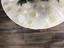 Load image into Gallery viewer, Celebrate A Holiday Christmas Tree Skirt - 50 Inch Diameter Golden, White and Silver Snow Flake Pattern for a Warm Traditional Look - Perfect Compliment to Your Christmas Decorations
